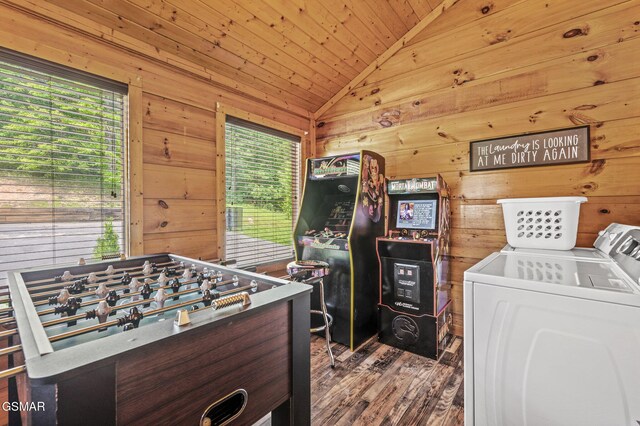 recreation room featuring washing machine and dryer, wooden walls, plenty of natural light, and lofted ceiling