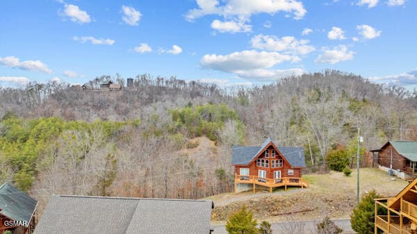 drone / aerial view with a wooded view