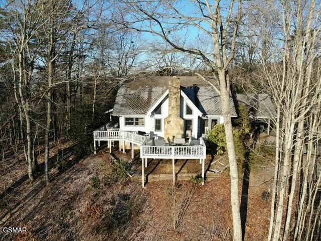 rear view of property featuring a deck