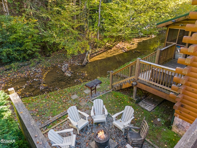 view of yard featuring an outdoor fire pit and a wooden deck