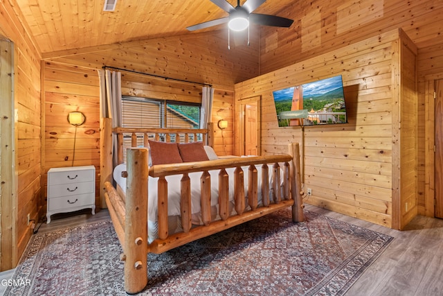 bedroom with wood ceiling, dark wood-type flooring, wooden walls, high vaulted ceiling, and ceiling fan