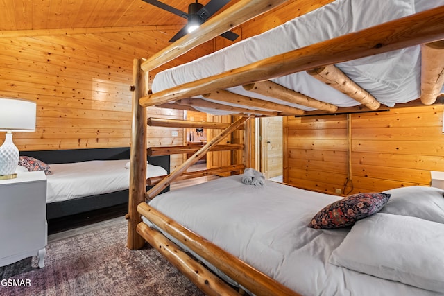 carpeted bedroom featuring ceiling fan, wood walls, wood ceiling, and vaulted ceiling