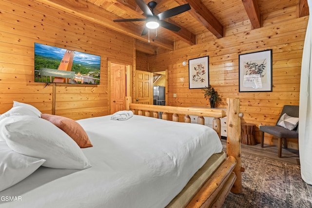 bedroom with wood walls, beamed ceiling, ceiling fan, and wood ceiling