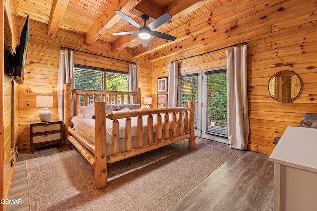 bedroom with wood walls, beam ceiling, dark wood-type flooring, and wooden ceiling