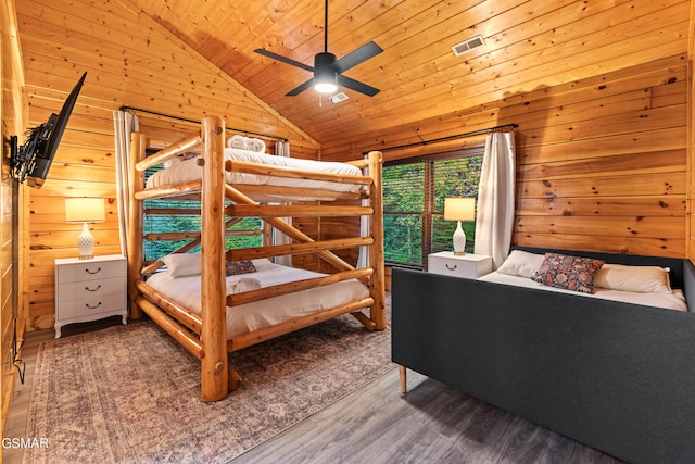 bedroom featuring hardwood / wood-style floors, wood ceiling, wooden walls, high vaulted ceiling, and ceiling fan