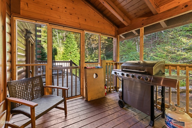 sunroom featuring wood ceiling and lofted ceiling with beams