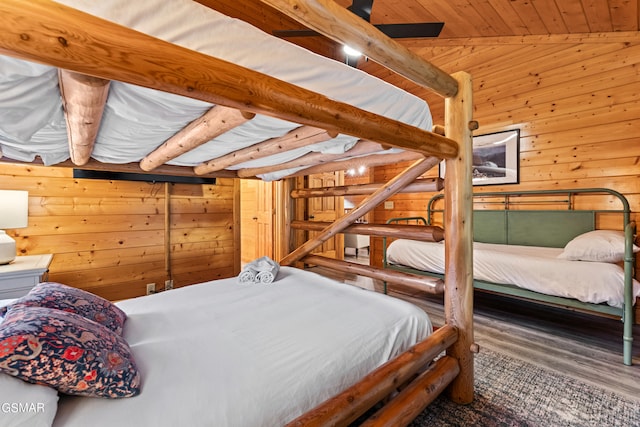 bedroom featuring wood ceiling, wood walls, and wood-type flooring