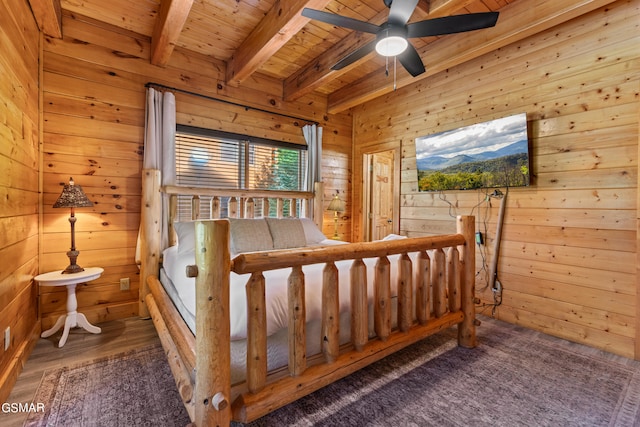 bedroom with wood ceiling, beam ceiling, dark wood-type flooring, and wooden walls