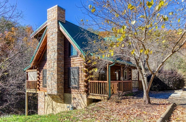 3416 Merlin Way, Pigeon Forge, TN 37863 - view of side of property featuring a chimney, log siding, and covered porch