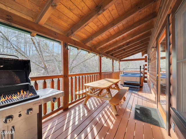 wooden terrace featuring a hot tub