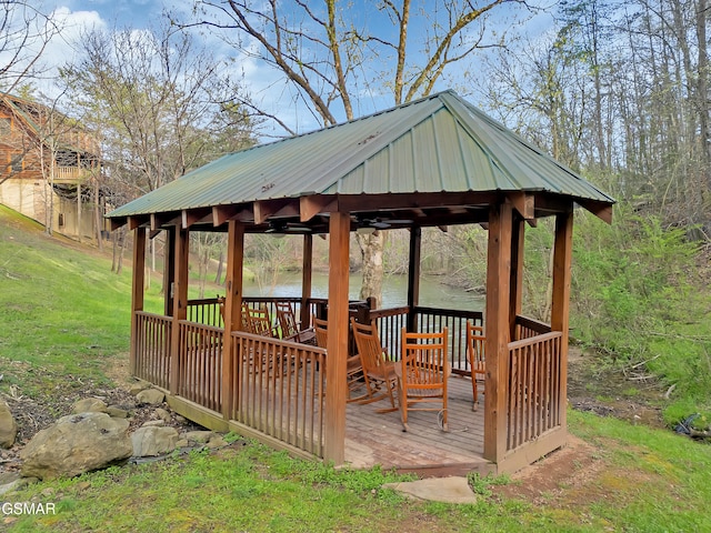 deck with a yard, a gazebo, and a water view