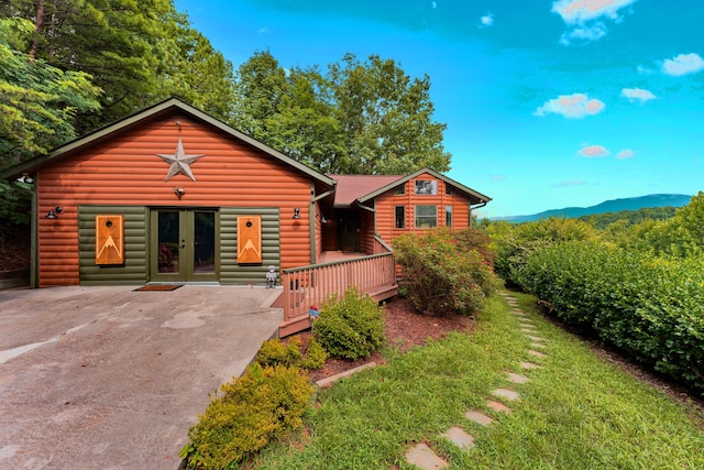 log home with a mountain view and french doors