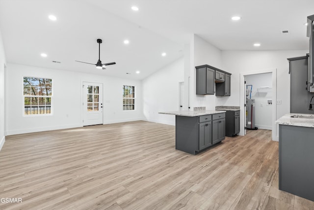 kitchen featuring ceiling fan, gray cabinets, light hardwood / wood-style floors, and vaulted ceiling