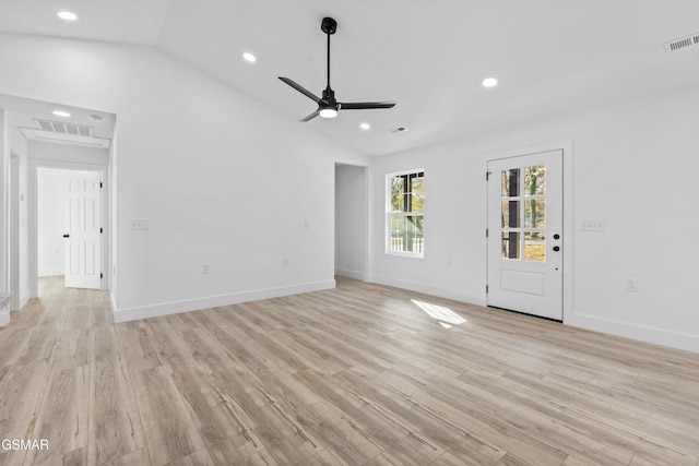 unfurnished living room featuring ceiling fan, light hardwood / wood-style floors, and vaulted ceiling