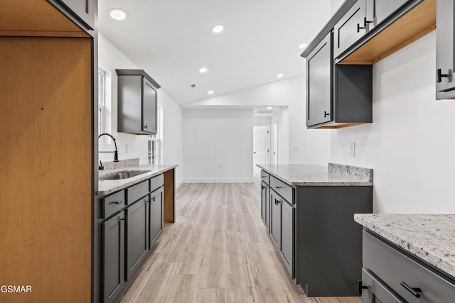 kitchen featuring gray cabinetry, sink, and light wood-type flooring