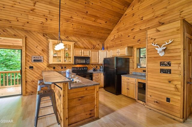 820 Pinnacle Vista Rd, Gatlinburg, TN 37738 - kitchen with black appliances, a peninsula, a breakfast bar area, glass insert cabinets, and vaulted ceiling