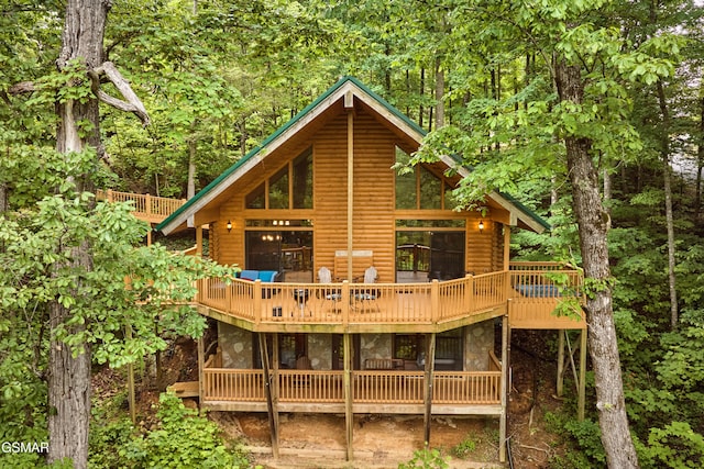 820 Pinnacle Vista Rd, Gatlinburg, TN 37738 - back of house featuring faux log siding, stone siding, a deck, and a wooded view