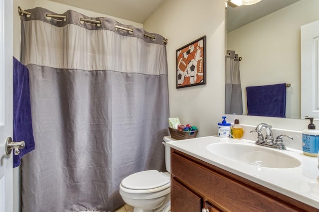 bathroom with vanity, curtained shower, and toilet