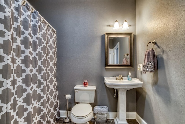 bathroom featuring tile patterned flooring and toilet