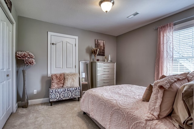 carpeted bedroom with a closet