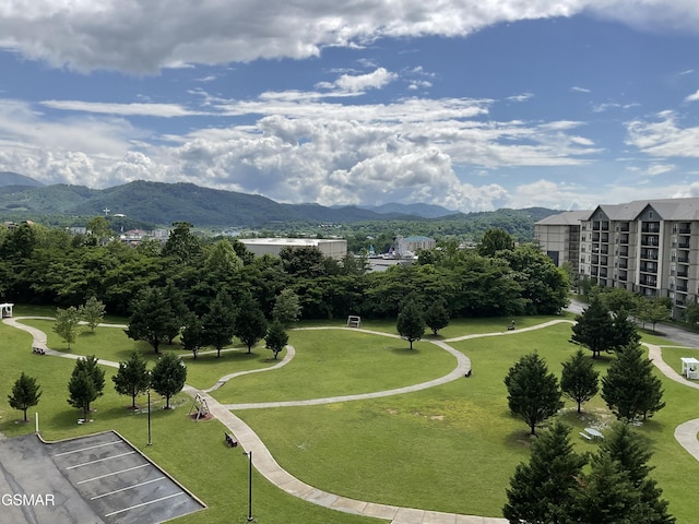 surrounding community featuring a mountain view and a yard