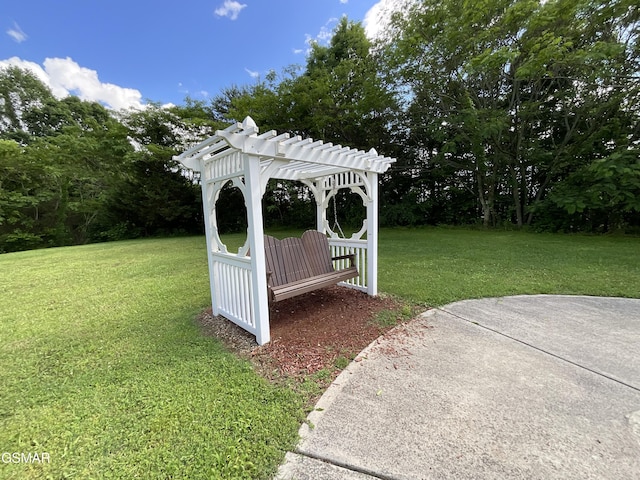view of grassy yard featuring a pergola and view of scattered trees