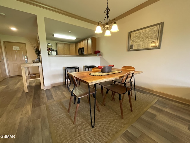 dining space with crown molding, dark wood-type flooring, and baseboards