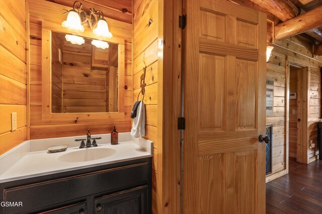 2436 Smoky Vista Way, Sevierville, TN 37862 - bathroom with wood walls, wood finished floors, vanity, and beam ceiling