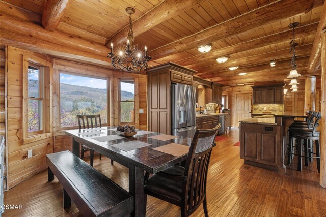2436 Smoky Vista Way, Sevierville, TN 37862 - dining room with a chandelier, hardwood / wood-style floors, wooden ceiling, beamed ceiling, and a mountain view