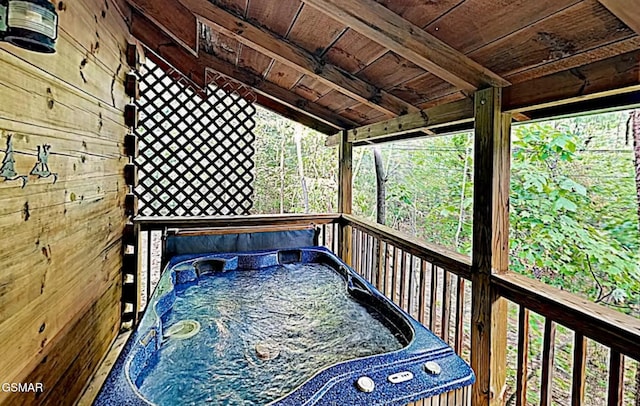 wooden terrace featuring a hot tub