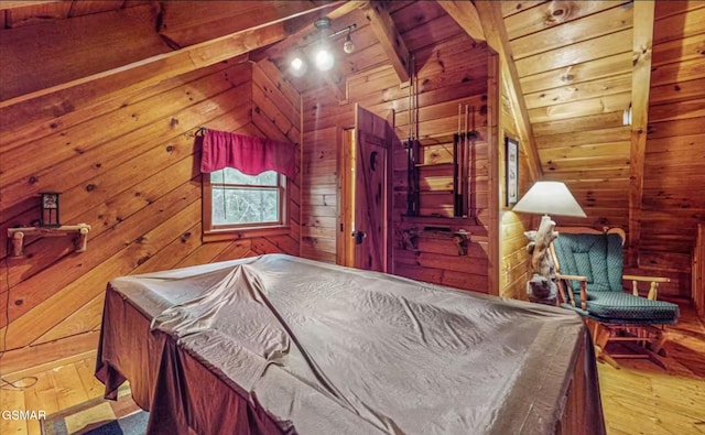 bedroom with wood ceiling, hardwood / wood-style flooring, lofted ceiling with beams, and wood walls