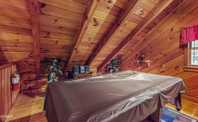 bedroom featuring vaulted ceiling with beams, wooden walls, light hardwood / wood-style floors, and wooden ceiling