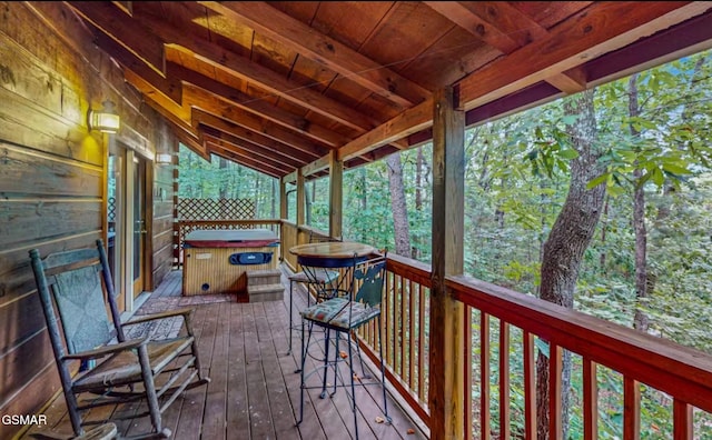 wooden terrace with a hot tub