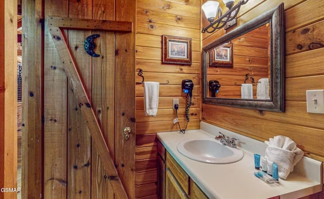 bathroom with vanity and wooden walls