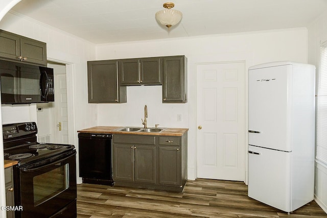 kitchen with ornamental molding, sink, black appliances, and wooden counters