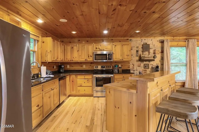 2336 Breezy Rd, Sevierville, TN 37876 - kitchen featuring stainless steel appliances, light brown cabinets, wood ceiling, recessed lighting, and a kitchen bar
