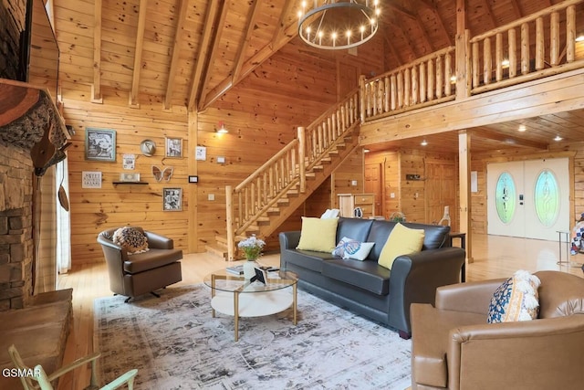 2336 Breezy Rd, Sevierville, TN 37876 - living room with stairs, wooden walls, wood finished floors, a chandelier, and high vaulted ceiling