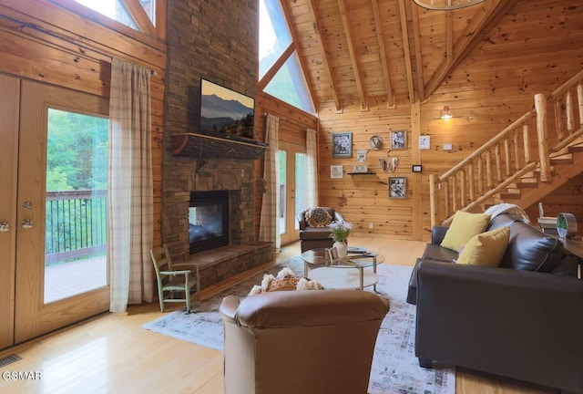 2336 Breezy Rd, Sevierville, TN 37876 - living area featuring wood finished floors, plenty of natural light, stairs, wood walls, and high vaulted ceiling