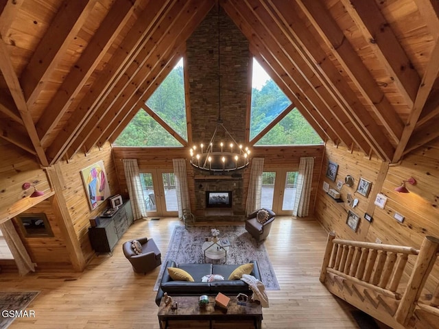 2336 Breezy Rd, Sevierville, TN 37876 - living area featuring wooden walls, high vaulted ceiling, light wood finished floors, healthy amount of natural light, and french doors