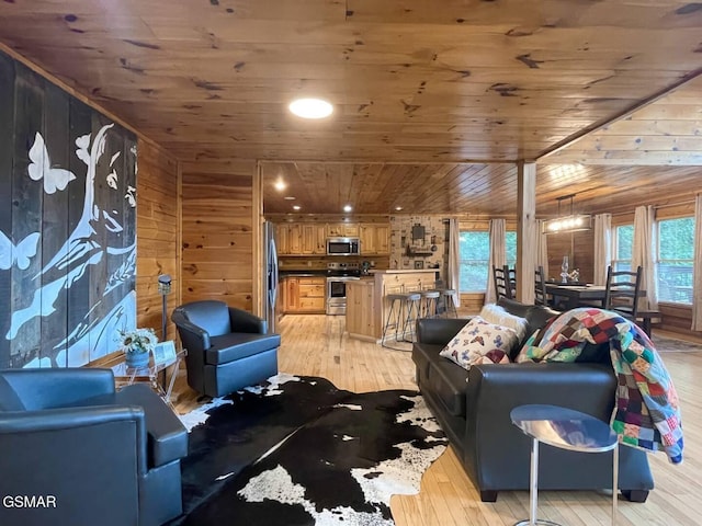 2336 Breezy Rd, Sevierville, TN 37876 - living area with wood ceiling, wooden walls, and light wood-style floors