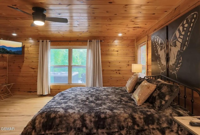 2336 Breezy Rd, Sevierville, TN 37876 - bedroom with light wood-style flooring, wood ceiling, multiple windows, and wood walls