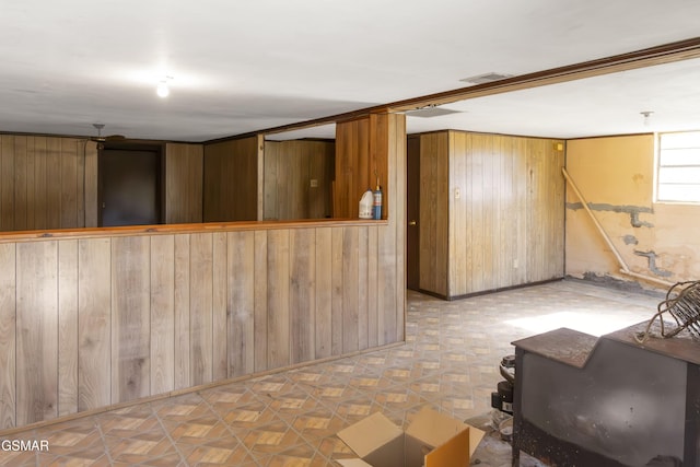 basement featuring wood walls