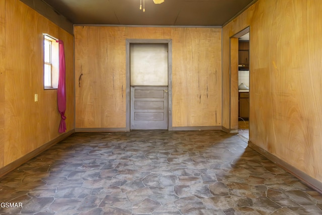 spare room with wood walls