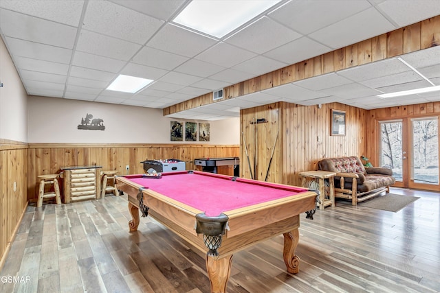 recreation room featuring wood finished floors, a drop ceiling, visible vents, pool table, and wainscoting