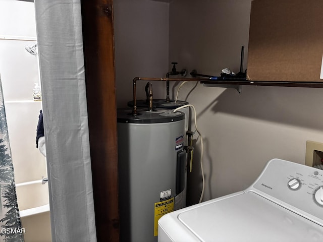 utility room featuring water heater and washer / dryer