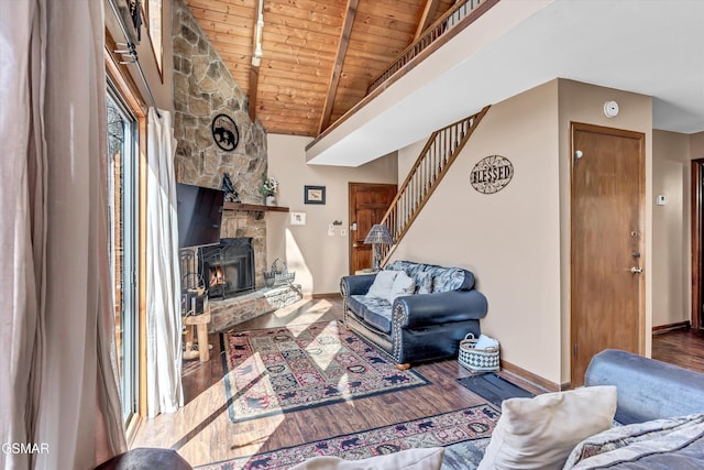 living area with wood ceiling, stairway, a fireplace, lofted ceiling with beams, and wood finished floors