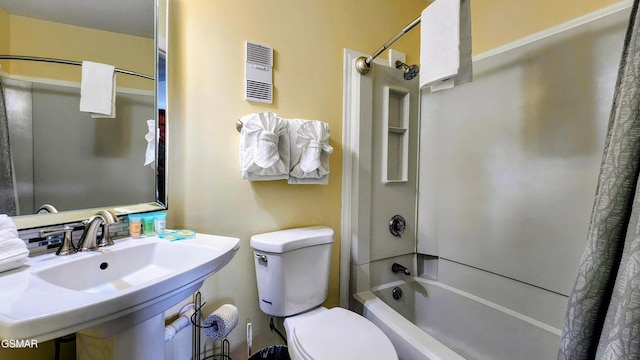 full bathroom with toilet, shower / bathtub combination with curtain, and sink