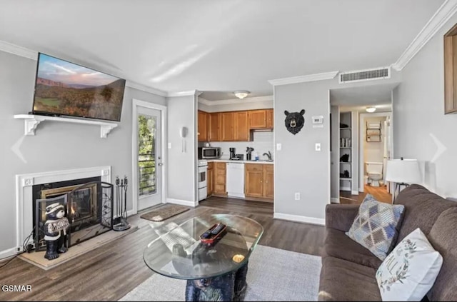 living room with dark hardwood / wood-style floors and crown molding