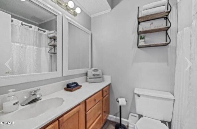 bathroom featuring vanity, curtained shower, toilet, and crown molding