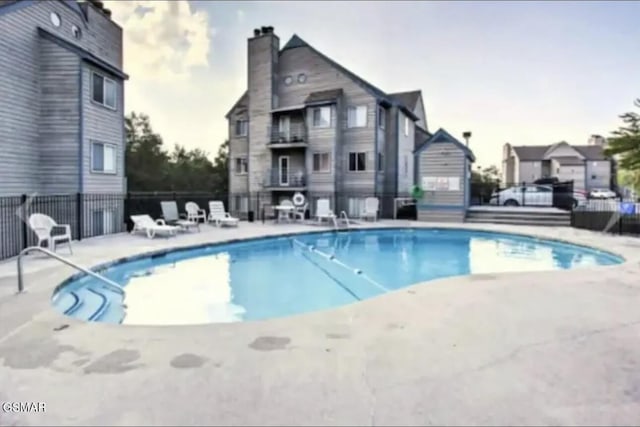 view of swimming pool with a patio